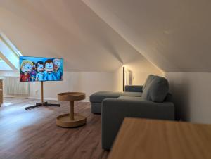 a living room with a couch and a flat screen tv at Bytovka1962 in Manětín