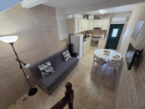 a living room with a couch and a table at Casa Centro Montargil in Montargil