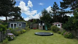 a backyard with a trampoline in the grass at Haus SandRast in Westerland