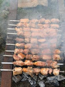 a grill with a bunch of food on it at GuestHouse NaSHGOBI in Ushguli