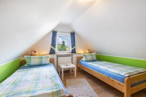 a room with two beds in a attic at Ferienhof Schade in Eslohe