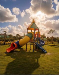 a playground with a slide in a park at EM Homes Modern 1-Bedroom Apartment with Pool 15 Minutes from JKIA Airport in Marimbeti
