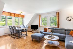 a living room with a couch and a table at Ferienhof Schade in Eslohe