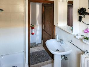 a bathroom with a sink and a toilet and a tub at Il Chiostro di Ribot in Lugnano in Teverina
