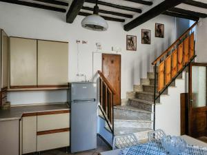 a kitchen with a refrigerator and a staircase at Il Chiostro di Ribot in Lugnano in Teverina +30 photos
