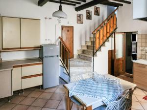 a kitchen with a refrigerator and a table in it at Il Chiostro di Ribot in Lugnano in Teverina