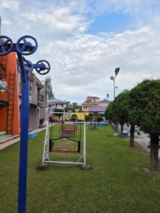 a park with a bench on the grass at Villa MountView No 88 Berastagi View in Berastagi