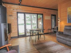 a living room with a table and a couch at Villa Visioduuri in Savonlinna