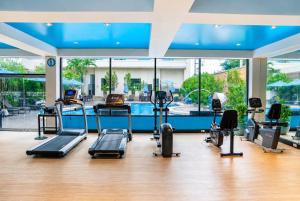 a gym with several treadmills and a swimming pool at The Bayview Hotel Pattaya in Pattaya