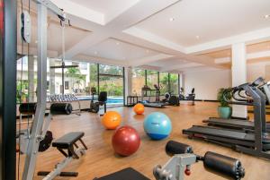 a gym with exercise equipment and exercise balls at The Bayview Hotel Pattaya in Pattaya