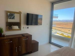 a bedroom with a dresser and a mirror and a window at Mountains and sea in Boghaz