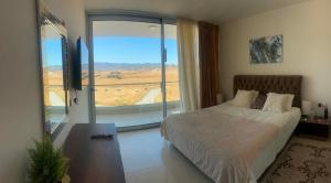 a bedroom with a bed and a large window at Mountains and sea in Boghaz +60 photos