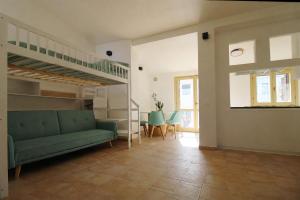 a living room with a green couch and a staircase at Casa Conti Trivelli 2 in Vasto