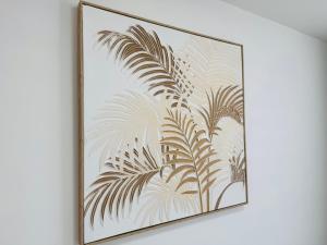 a framed picture of a plant on a wall at Deluxe One-Bedroom Apartment, Central in Swindon