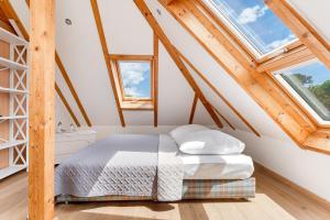 a bedroom with a bed and two windows at Möwennest in Vitzdorf