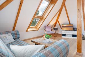 a living room with two couches and a tv at Möwennest in Vitzdorf +19 photos
