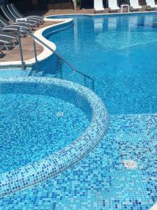 a large swimming pool with blue tiles on it at Boulevard Sea Residenz 250 meter zum Sandstrand in Sunny Beach +35 photos