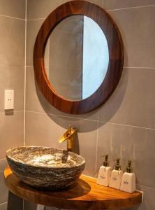 a bathroom with a sink and a mirror at Lăng Cô Plaza in Thôn An Hảo