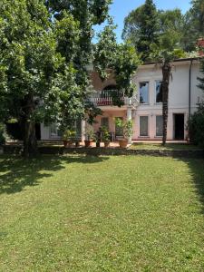 a house with a large lawn in front of it at Božič Residence in Vipava