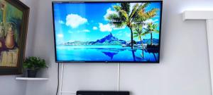 a flat screen tv hanging on a wall at Big,Smart & Comfort ! in Kalamata