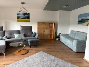 a living room with a couch and a table at Villa Basilika - Ferienwohnung Prüm in Prüm