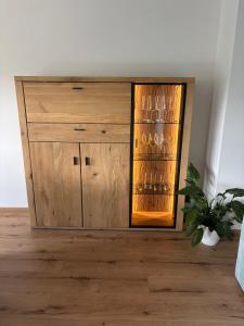 a wooden cabinet with a glass door on a floor at Villa Basilika - Ferienwohnung Prüm in Prüm