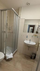 a bathroom with a shower and a sink at Hotel am Bayrischen Platz in Leipzig +23 photos