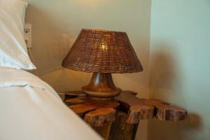 a lamp on a wooden table next to a bed at Lăng Cô Plaza in Thôn An Hảo