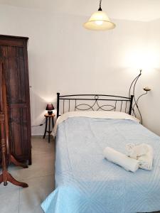 a bedroom with a bed with two towels on it at Levanta Apartment in Kythira