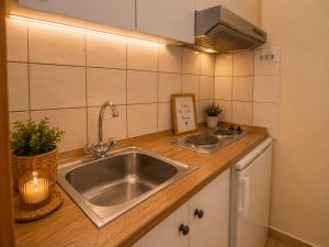 a kitchen with a sink and a counter top at Panorama Plataria Ionio Studios&Apartments in Plataria +39 photos