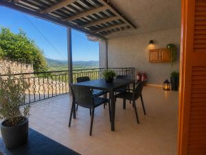a table and chairs on a balcony with a view at Panorama Plataria Ionio Studios&Apartments in Plataria