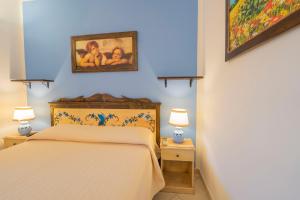 a bedroom with a bed and two night stands with lamps at Sole del Mediterraneo in Otranto
