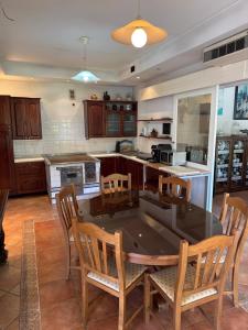 a kitchen with a table and chairs and a kitchen with a counter at Božič Residence in Vipava