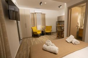 a room with a bed with towels on it at Elysian Studios in Mavrovouni