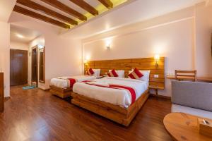 a bedroom with two beds and a couch at DANFÉ Lodge Halesi in Lamidanda +12 photos