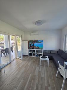 a living room with a couch and a table at Matoc apartments in Murter