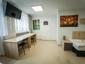 a room with a desk and a bed and a bedroom at Dom Sportowca in Krosno