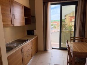 a kitchen with a large window with a view of a city at Residenza La Signora vista mare con ascensore in Marotta