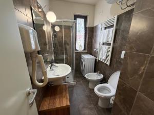 a bathroom with a sink and a toilet and a shower at Residenza La Signora vista mare con ascensore in Marotta +29 photos
