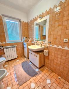 a bathroom with a sink and a toilet at Apartman Ruza 2 in Opric +37 photos