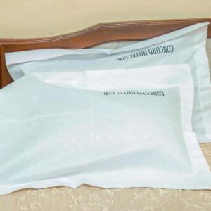 a piece of paper sitting on top of a bed at Camp seleu in Dar es Salaam