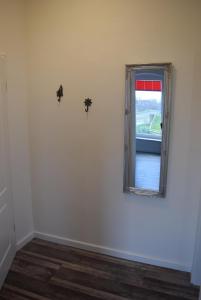 a room with a window with a cross on the wall at Heimathafen über dem Hafen - Pub in Pellworm +16 photos