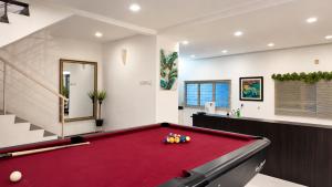 a billiard room with a red pool table at Bungalow Perkasa in Kuala Lumpur