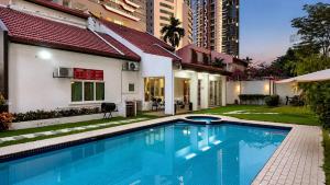 a swimming pool in the backyard of a house at Bungalow Perkasa in Kuala Lumpur
