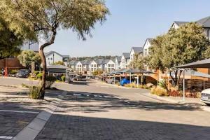 a street in a town with houses and a tree at Above Cozy Corner Amsterdam in Northriding