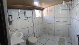 a bathroom with a toilet and a sink at Pousada Catuaí in Siqueira Campos +29 photos