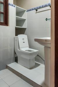 a bathroom with a toilet and a sink at Comfort Apartment in Bālāju +18 photos