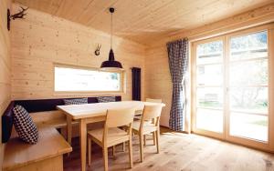 a wooden dining room with a table and chairs at CASALPIN Chalets in Brand +37 photos