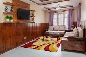 a living room with a couch and a tv at Comfort Apartment in Bālāju