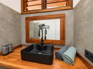 a bathroom with a sink and a mirror at Maison le Rêve in Nosy Be +30 photos